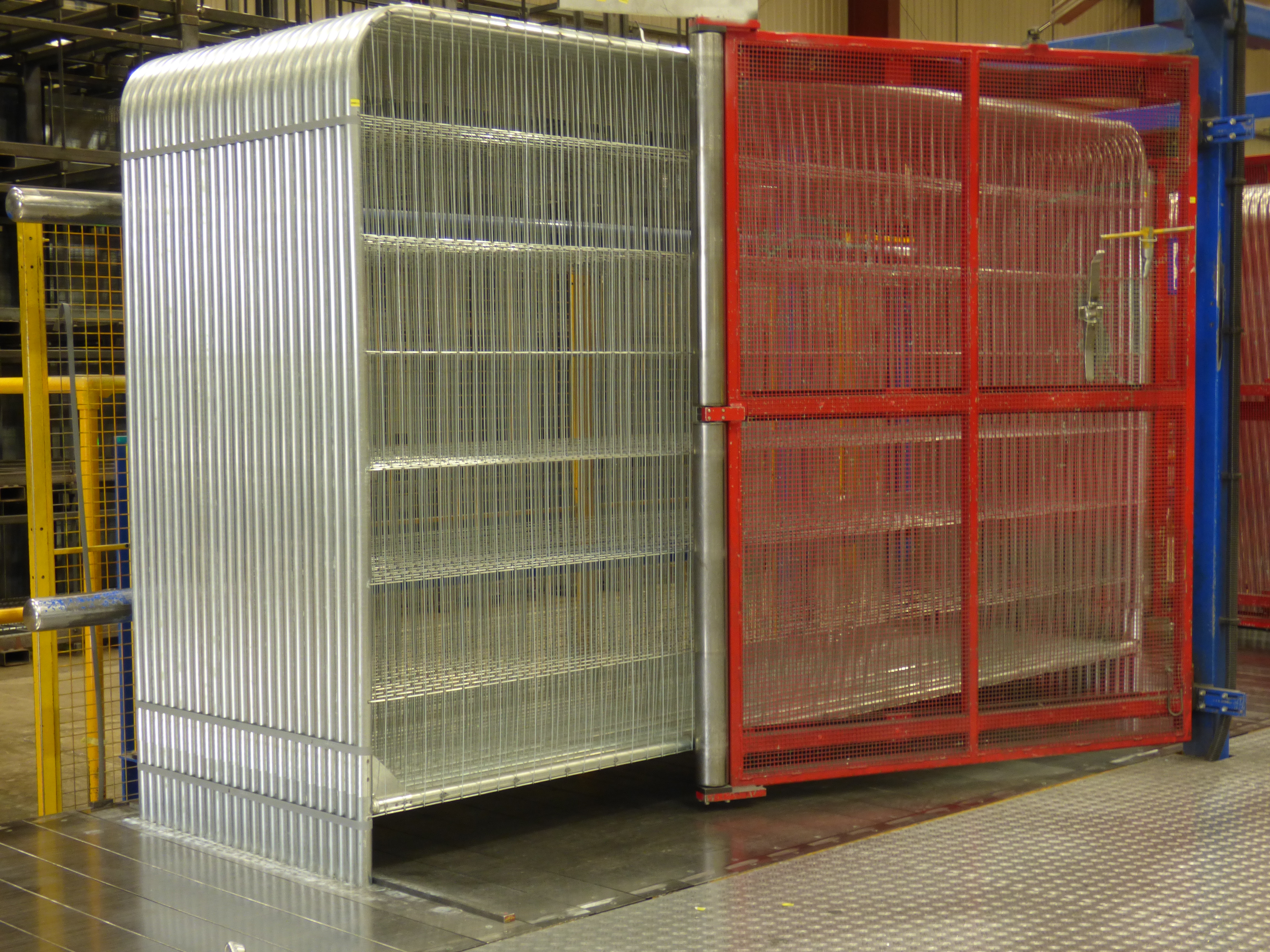 Temporary welded fence panels in a factory photographed by MykelH, CC BY-SA 4.0; full source and credit in the article